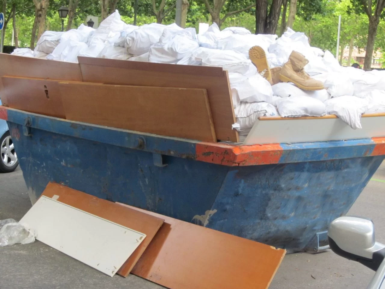 overfilled skip with wooden planks on the side