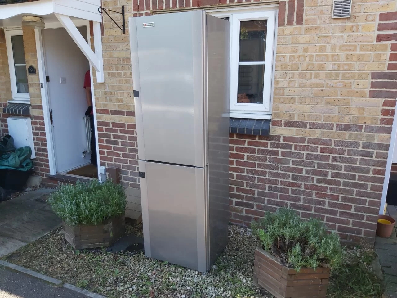 household fridge left outside of house ready for collection and disposal