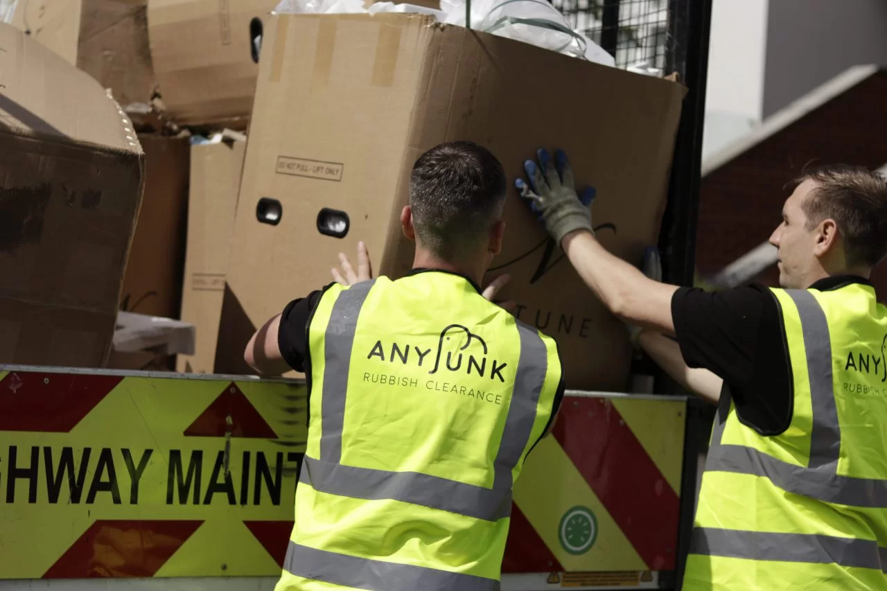 man and van removals anyjunk contractors putting waste into back of a van cardboard boxes man and van near me